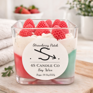 candle in a square clear vessel, tricolor candle with green, red, and white wax in a triangle stacked design, wood wick, straberry embeds. Front has the 4S Candle Co logo labeled with the name Strawberry Patch. Label has soy wax, Begs, Ok and 8oz/227g printed.